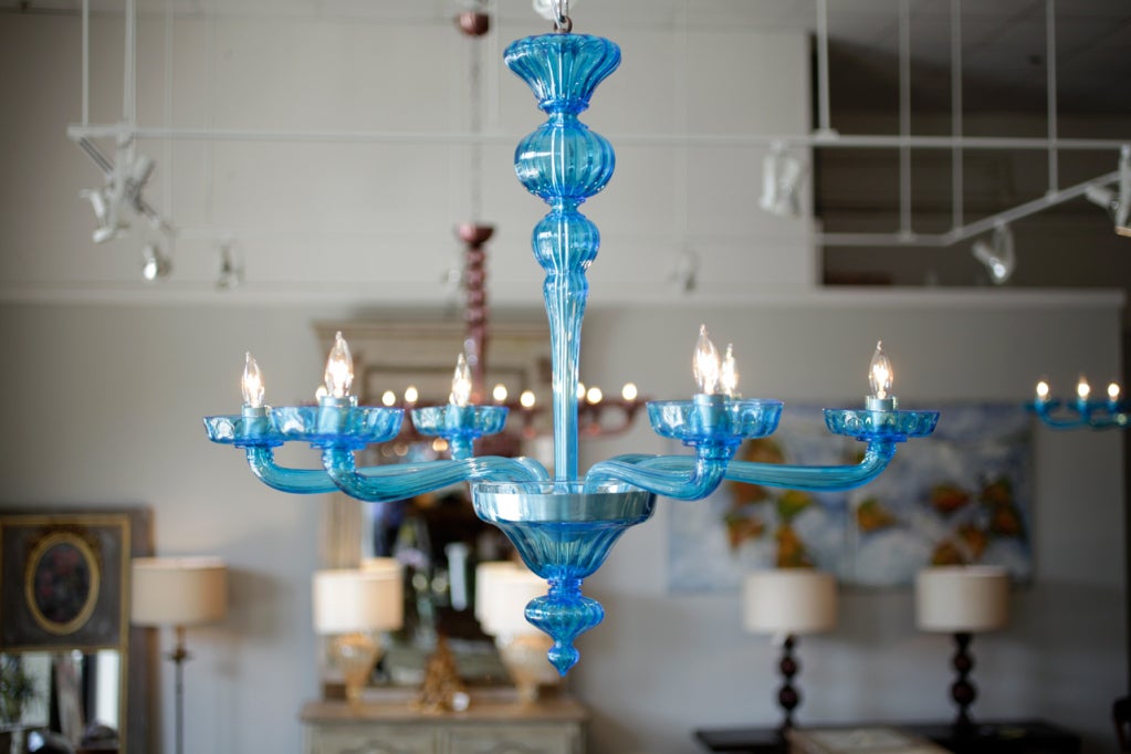 Cerulean blue Murano glass chandelier with 6 branches. Height including chain and matching glass canopy is 44.25 inches. A very nice transitional piece that will shimmer in any room.
