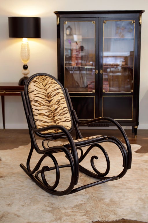 Antique Thonet ebonized bamboo rocking chair with tiger print upholstery.