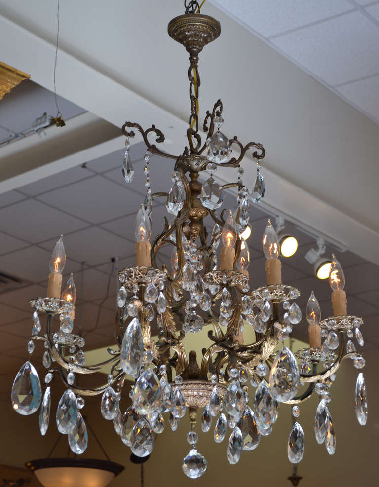 An exceptional gilt bronze cast frame and a beautiful array of finely cut crystals make this Louis XIV style chandelier the piece of choice for your dining room or living area. Rewired for the US market.