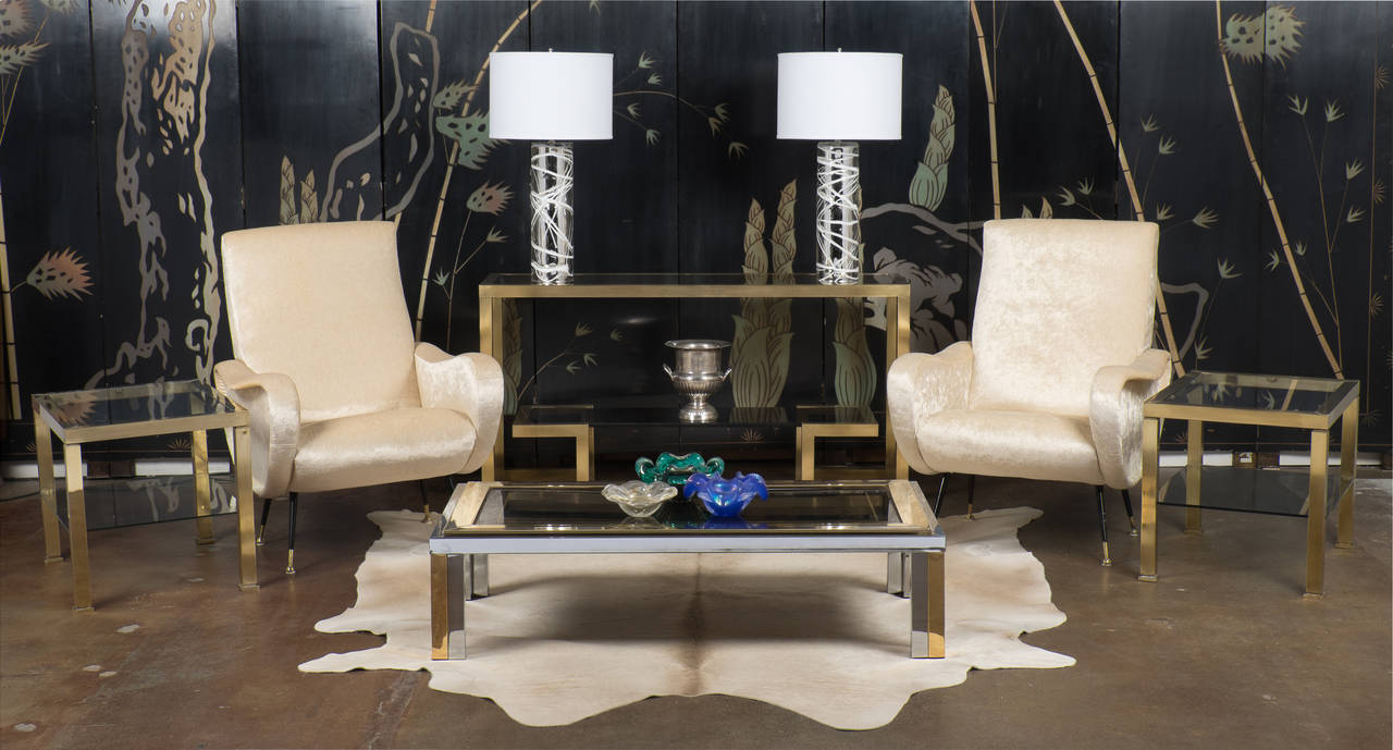 French vintage console table in solid brass with two smoked glass shelves, with a bold and elegant design by Maison Raphael. This is one of our favorites in this last shipment, because of its decorative impact.