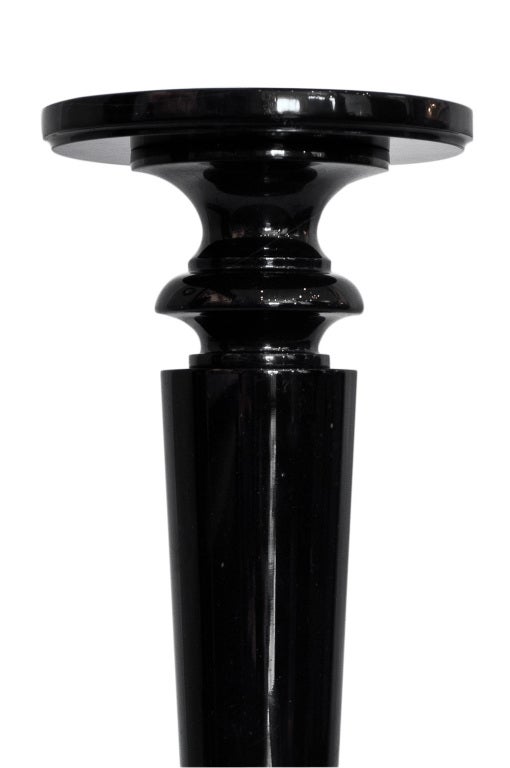 Vintage black marble pedestal with small white veins on top.