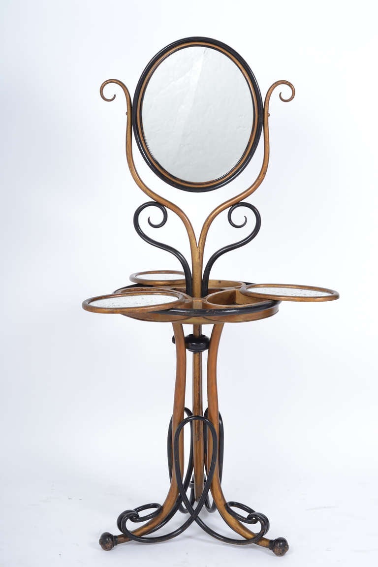 By August Thonet of the Austrian furniture company Gebruder Thonet (Brothers Thonet). Stunning and rare barber stand with three mirror topped compartments, intricate base with gold leafed and ebonized finish, original mirror, a fabulous