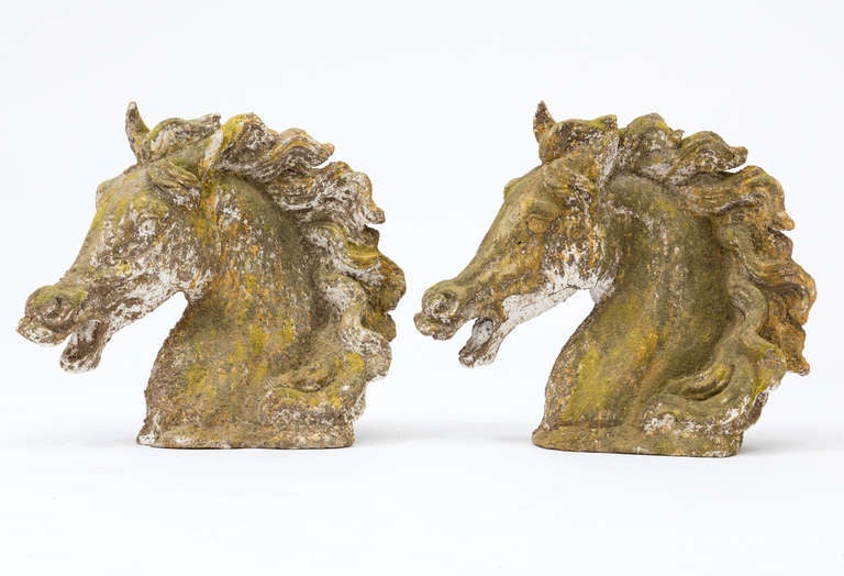Vintage French pair of reconstituted stone horse heads, beautifully aged. Priced individually.