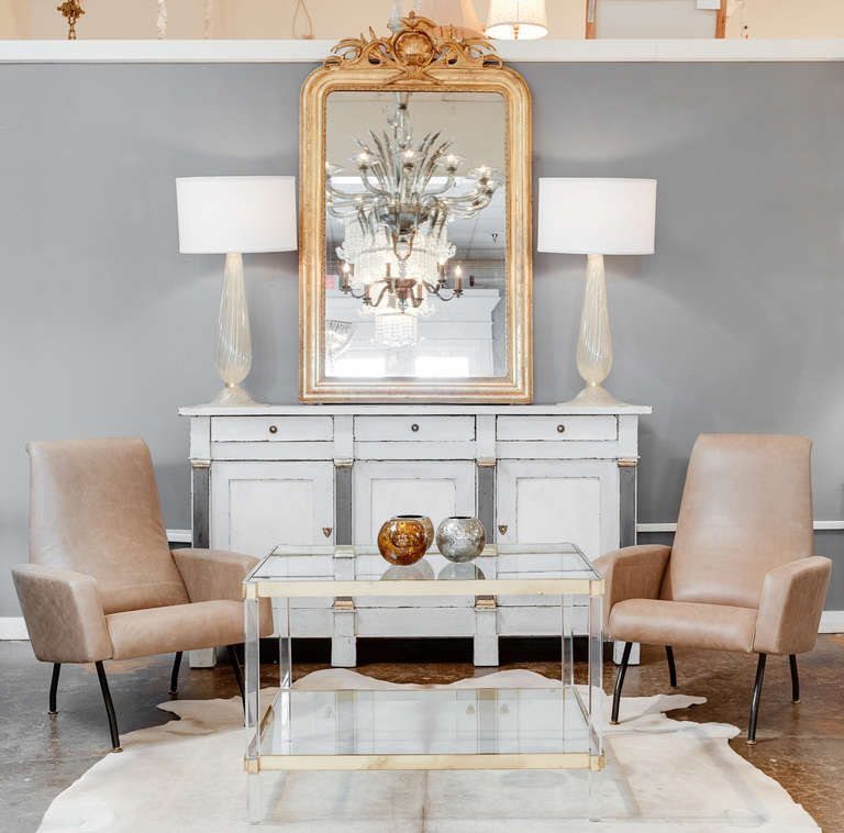 A unique tall side table of gilt brass and lucite in beautiful condition. Very strong craftsmanship.