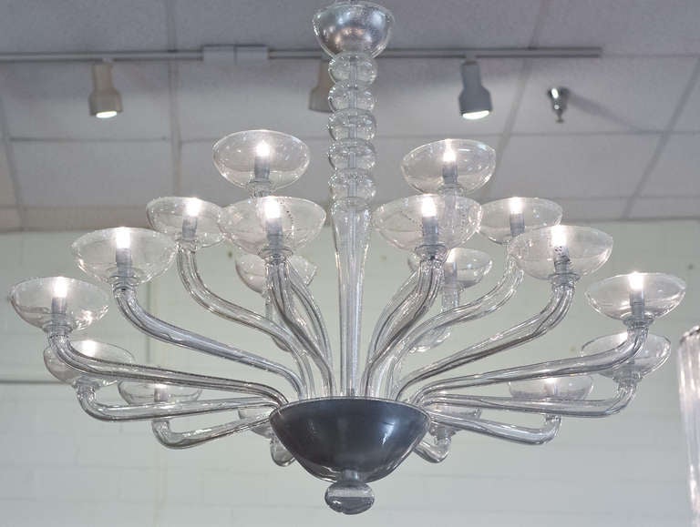 Fabulous Murano glass chandelier with silver leaf flecks fused in the handblown clear glass. 18 branches alternate between two levels. 18 candelabrum lights, rewired for the US.