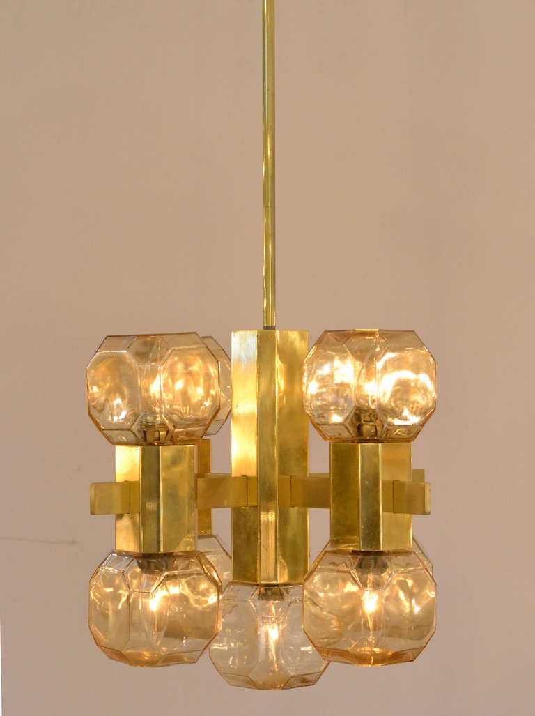 Gorgeous pair of vintage chandeliers, priced per chandelier. Gilt brass structure with smoked amber blown glass cubic elements. This pair is in stunning vintage condition. The height including the brass rod and canopy is 36.5 in.