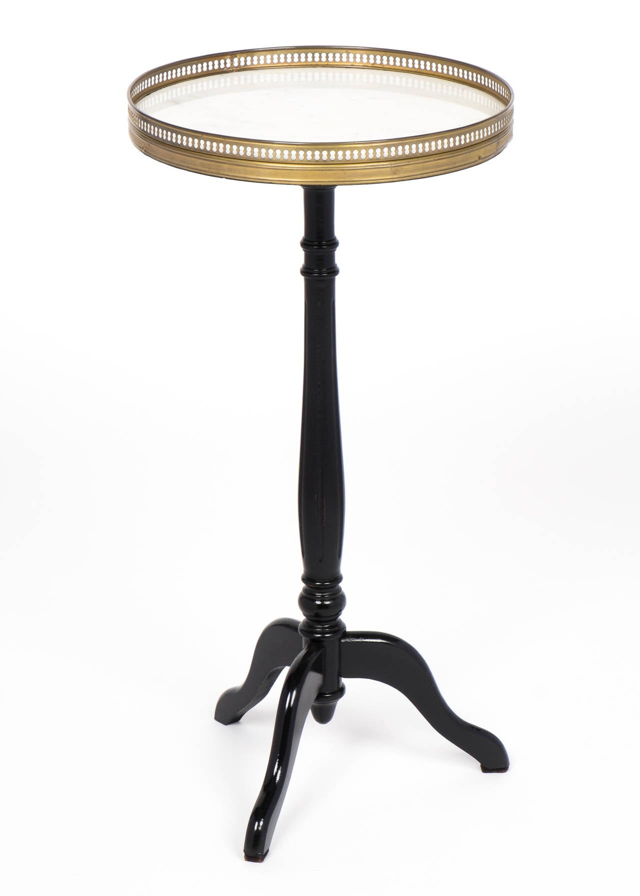 French Louis XVI style side table with an ebonized tripod base, French polished to a high gloss, and Carrara marble-top surrounded by a finely cast brass gallery. A comely perch for your drink or book.