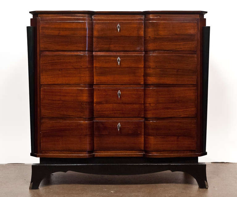 French Art Deco period rosewood chest with four drawers, original hardware, ebonized base, and a lustrous French polish finish. Extremely nice quality and beautiful bold and elegant proportions. All original keys, hardware.