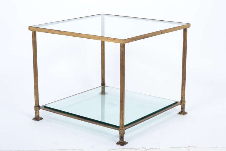 French vintage pair of side tables in gold leafed iron with two glass shelves in the manner of Jacques Adnet.