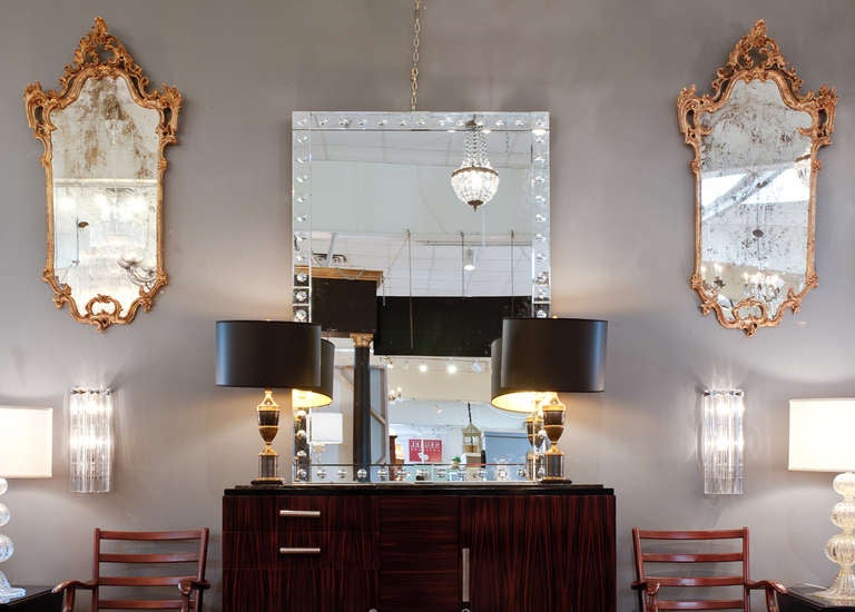 Italian baroque  pair of mirrors with gold leafed wooden frames and antiqued glass mirrors.