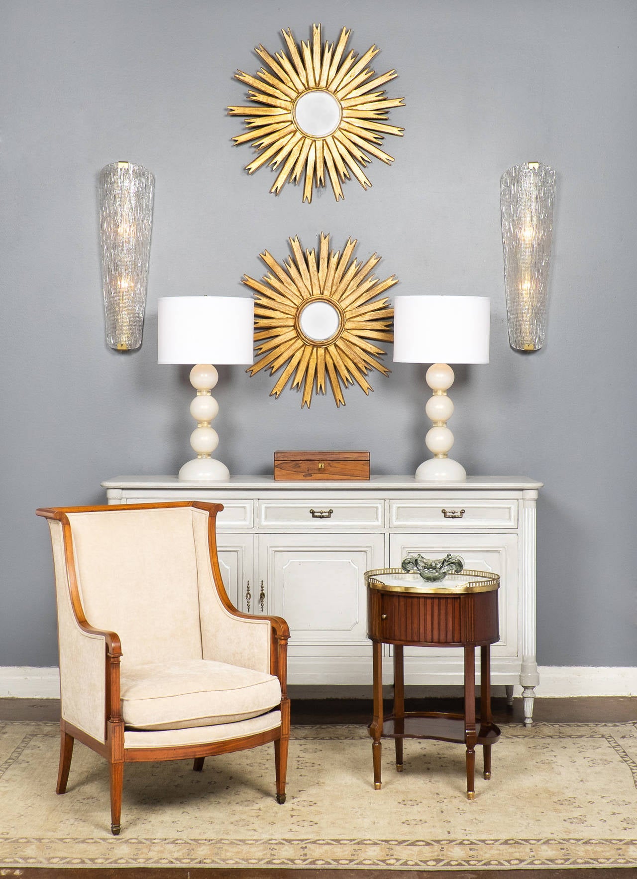 French 19th century Louis XVI style side table in solid mahogany with a lustrous French polish finish, hand-carved fluting, oval white marble top with brass gallery. A sliding door fronts the cabinet and a kidney shaped bottom shelf.