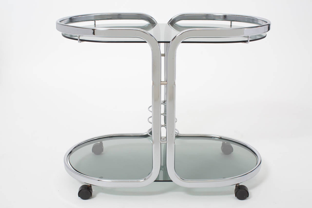 French vintage chrome bar cart with smoked glass shelves and bottle holders, on casters.