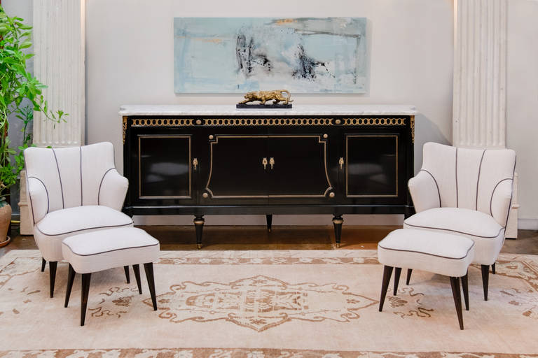 French Louis XVI buffet in the manner of Jansen with a beautiful Carrara marble top, a sumptuous French polish over an ebonized finish, and finely detailed bronze trim throughout. Curved sides are framed with fluted legs and 