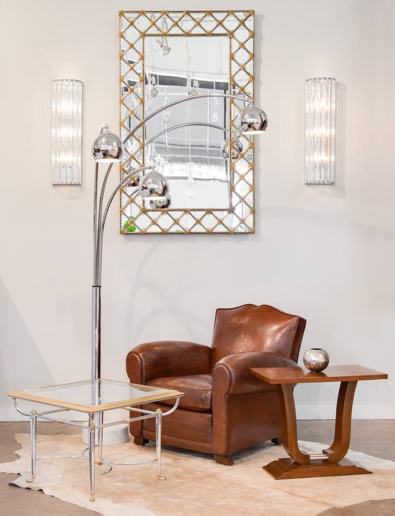 Vintage moustache-back club chair in original leather, patinated brass studs, professionally reconditioned, webbing, springs and leather, from France. Very comfortable.
