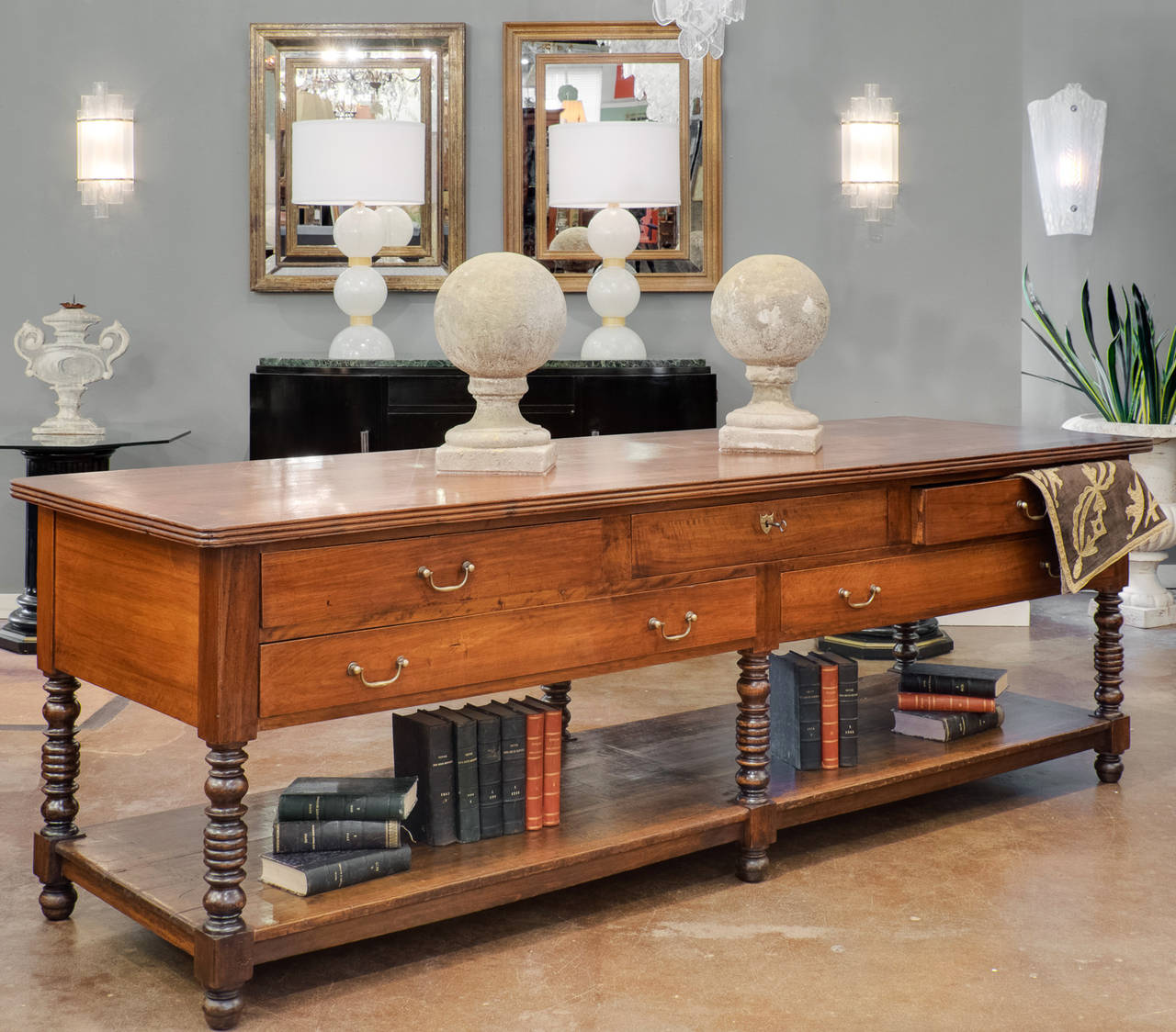 French antique silk trader's table from Lyon, France, in solid walnut with hand-turned legs. Five dovetailed drawers with original brass hardware. Excellent construction, a strong piece with the perfect proportions for a work table, whether it be in