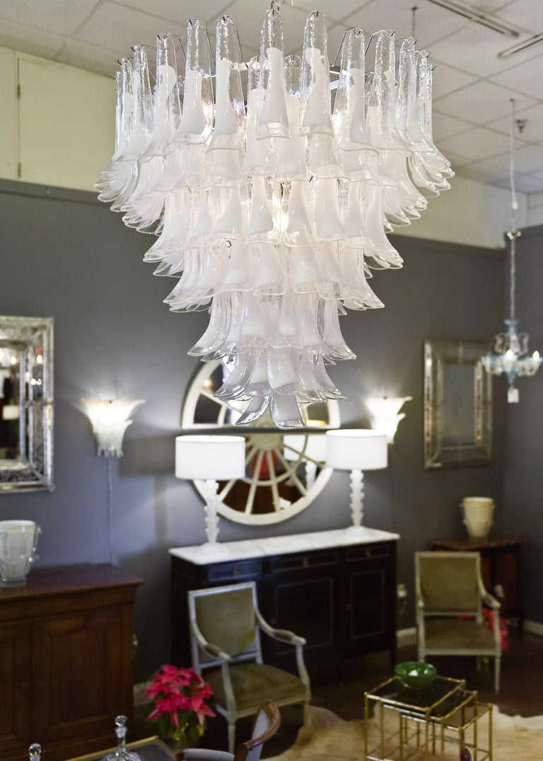 Handblown Murano glass chandelier seven tiers of clear and white glass petal-shaped pieces. Rewired to US standards. A dynamic architectural piece.

This fixture is currently located at our dealer's warehouse in Italy. Please contact us for a lead