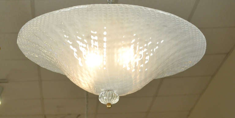 Italian handblown Murano glass ceiling fixture, rewired for the US. The bell curve and subtle texture of the opaline glass make this a stand out light fixture. Finished with a clear glass and brass finial. Made as a flush mount fixture or easily