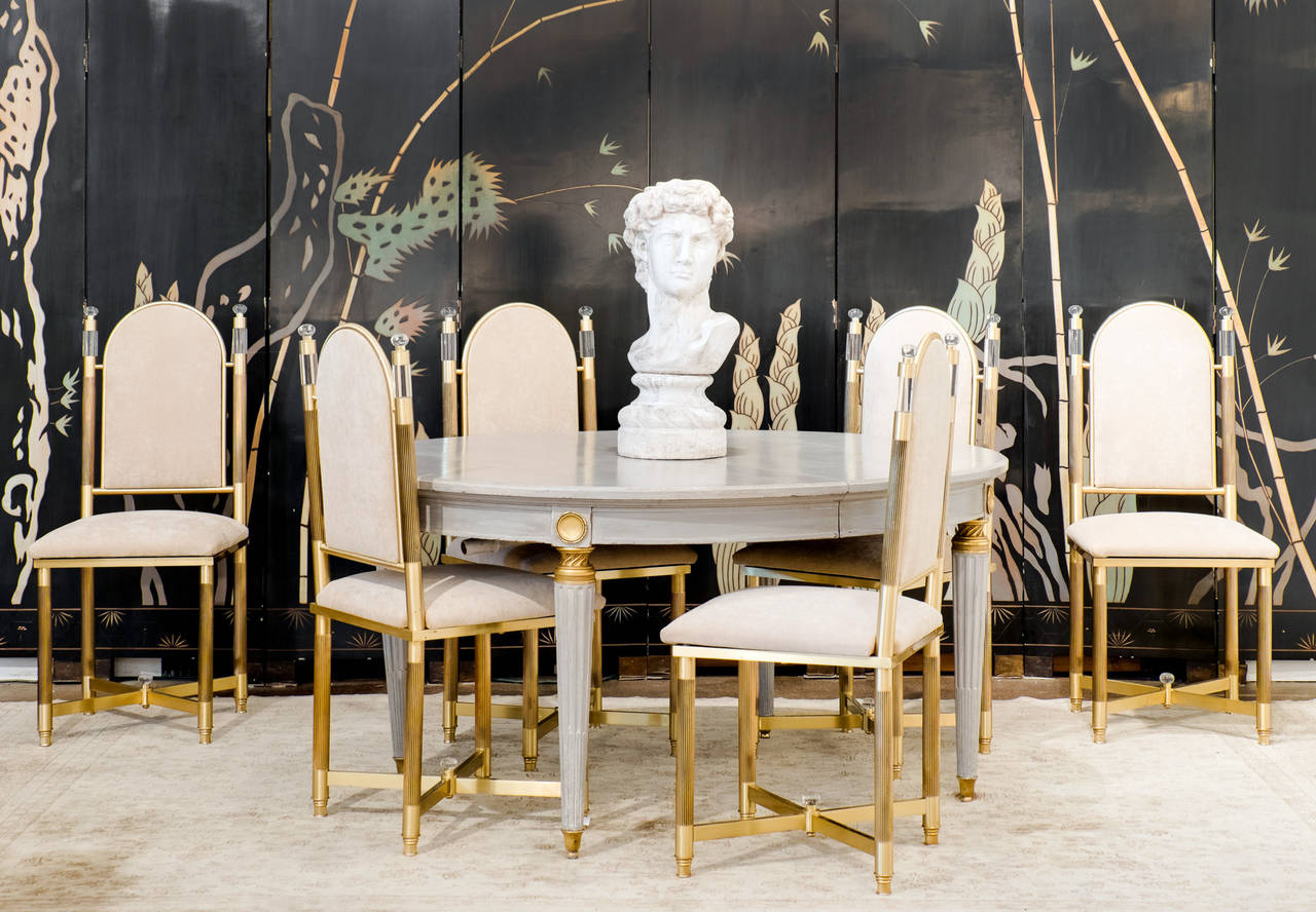 Fabulous Spanish vintage set of six dining chairs by Maison Valenti in solid brass and Lucite, professionally reupholstered in a beige velvet blend. These striking chairs have unparalleled style (we love the fluted legs and Lucite finials!) and very