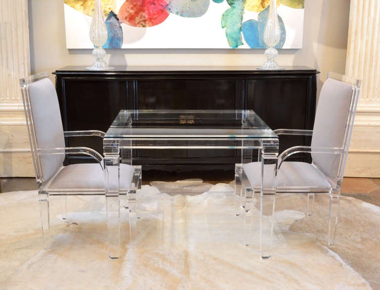 Italian vintage game table in lucite (clear acrylic) with tapered, beveled legs and a clear glass top. Manufacturer's sticker reads: Manufactured By Fabian, Rome-Italy. Four matching armchairs are also available.