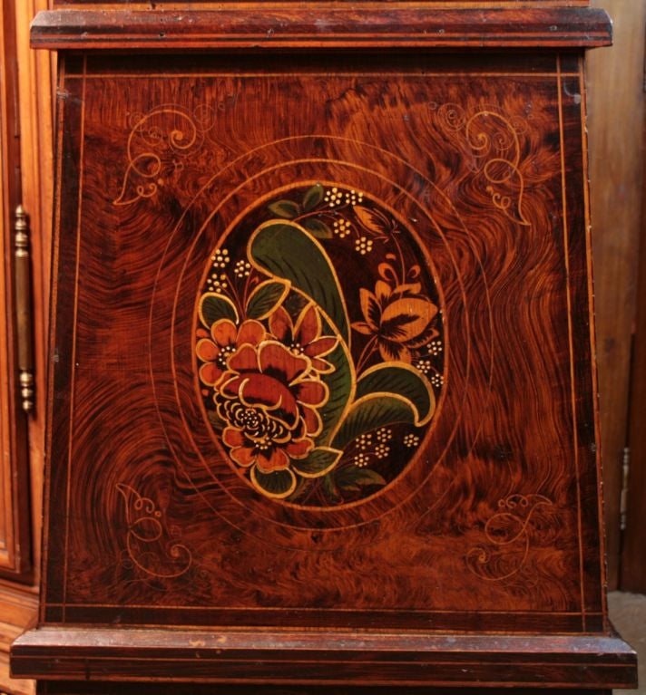 Fabulous Morbiers grandfather clock, all original, faux painted decor of flowers and wheat, movement in perfect working condition.  Enameled face, embossed brass crown of flowers and architectural details.