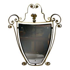 ITALIAN MID CENTURY PARCEL-GILT SHIELD FORM IRON MIRROR