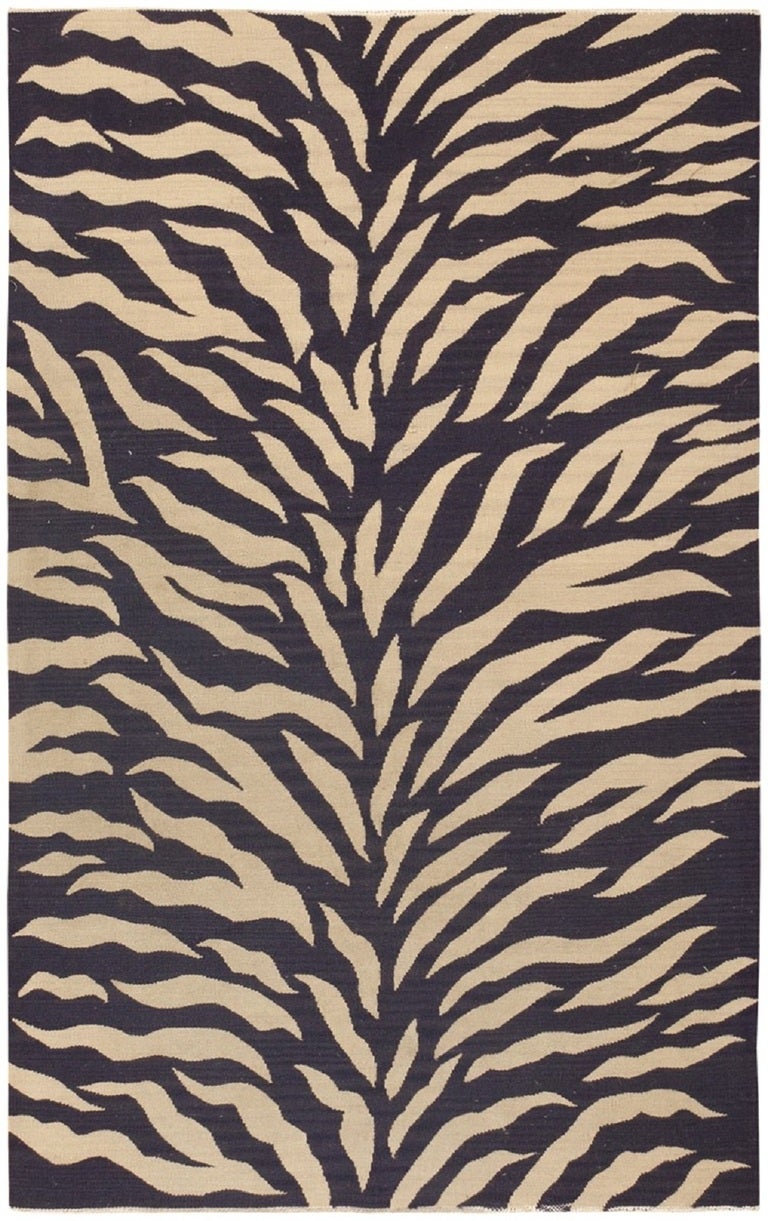 Ideal for modern interiors and elegant regency spaces, this exceptional vintage French Kilim showcases a time-honored zebra print pattern with foliate ecru stripes set over an exquisite midnight blue background. This chic variation on the