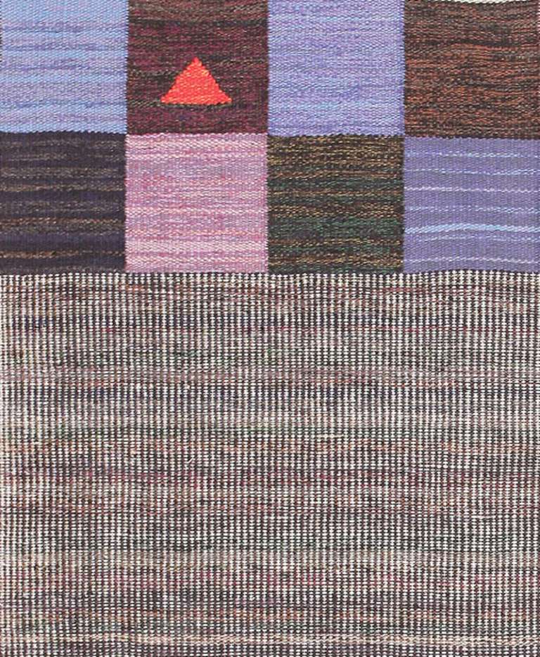 Exploring the art of simplicity and geometry, this vintage Swedish Kilim is a modernist delight that pairs patchwork-style checkerboard blocks with micro-plaid segments that have a tantalizing op-art effect. Striated color variations in low-chroma