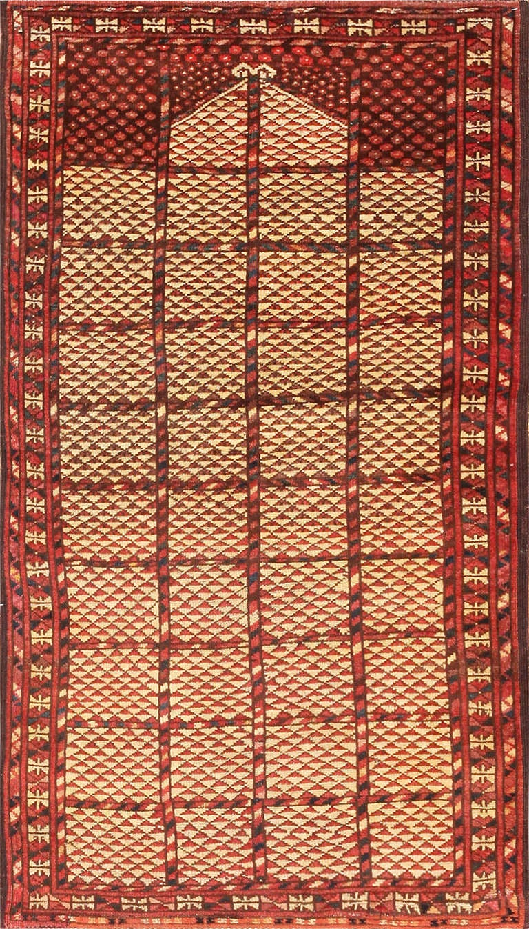This dazzling antique Afghan prayer rug displays a fantastic assortment of geometric repeating patterns that exemplify the Bashir group's preference toward miniaturization and small-scale ornamentation. The clear ivory and red field is intersected