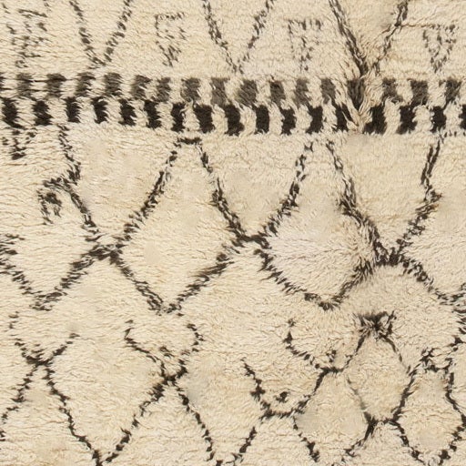 Latticework details and dividing checkerboard motifs rendered in a combination of Kohl black and walnut brown create an abstract allover pattern set over a chic papyrus-colored field. Often incorporating mutable elements, this Moroccan carpet