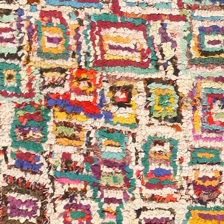 Vintage Moroccan Rug, Circa Mid 20th Century -- While many Moroccan rugs are known for their simplicity, subtly, and neutral colors, this rug shows just how versatile Moroccan rugs can be. While still containing the classic 