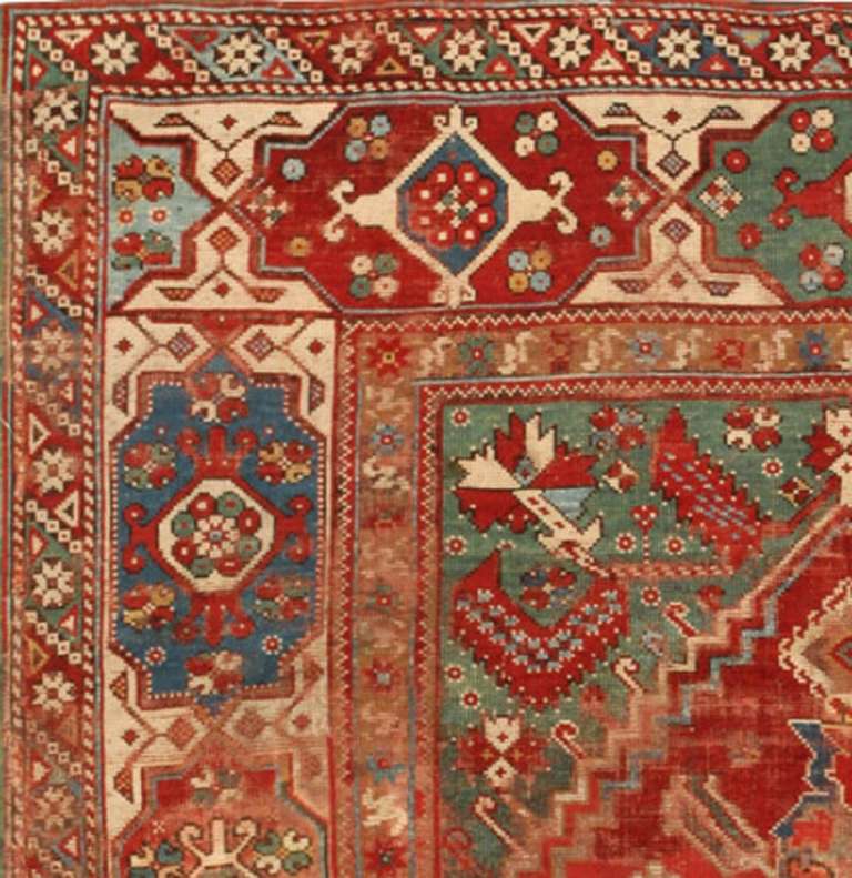 This unique Transylvanian carpet illustrates the far reaching influences that have blurred the borders between regional weaving traditions. Ram's horn motifs, goz symbols, tiny roundels and ancient protection symbols are used throughout the field