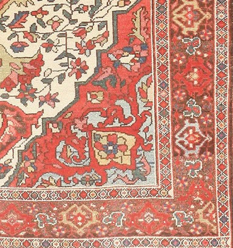 Beautifully colored and wonderfully appealing, this antique Persian medallion rug exemplifies the clarity and charming simplification of village designs from Malayer and the greater Hamadan region. Delicate curvilinear decorations with well-defined