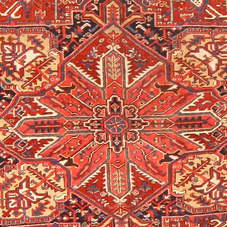Antique Room-Sized Persian Heriz Rug, Circa 1920 -- Saturated with images of rejuvenation and purity, a sanguine color palette of crimson and honeyed ivory highlights the luxurious pattern of this antique Persian Heriz rug. A resplendent medallion
