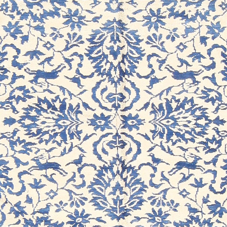 Vintage cotton Indian Agra rug, circa mid-20th century. A splendid shade of cornflower blue set against a white background augments the delicate details of this vintage Indian Agra rug, conjuring a fascinating dialogue between flora and fauna.