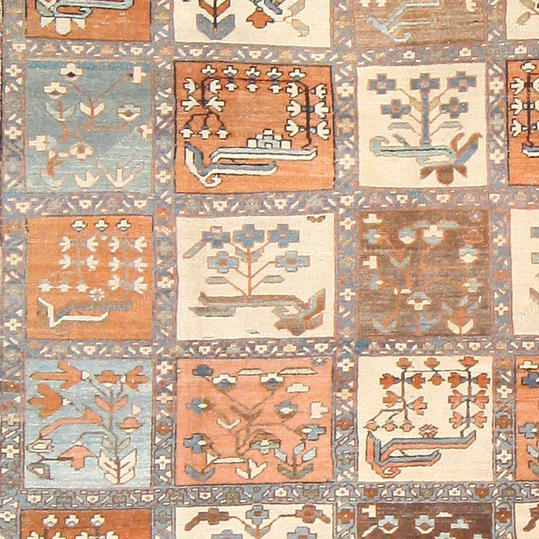 Antique Persian garden design Heriz rug, circa 1900. A complementary color scheme of sienna, cream and pumpkin orange, anchored with understated tones of blue, formulates a soothing and inviting atmosphere for this antique Persian Heriz rug.