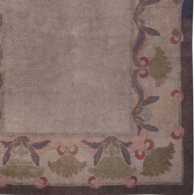 Antique Donegal rug, origin: Ireland, circa early 20th century classically styled, this outstanding antique Donegal rug from the famous weaving city of Donegal features understated floral borders drawn with graceful sweeping curves that are