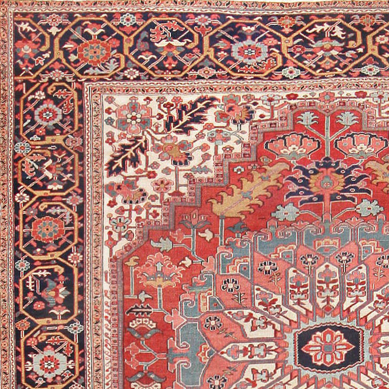 The stirring antique Persian rugs of Heriz-Serapi origin rugs are among the most intriguing of all Oriental rug styles, and this exceptional Heriz-Serapi is a testament to that tradition. Featuring a graphic, floral monumental medallion, expertly