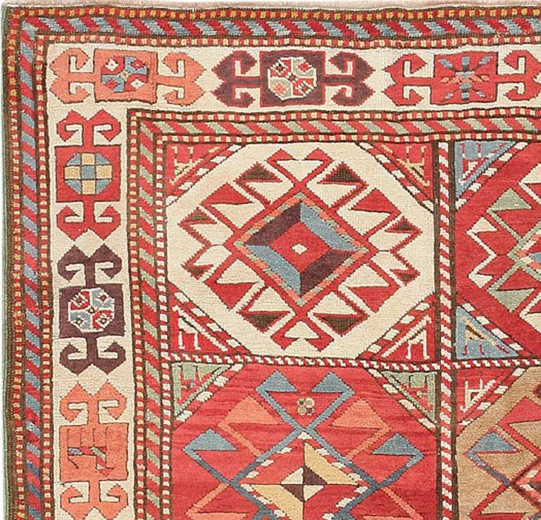 Here is a mesmerizingly gorgeous antique Oriental rug: a traditional Caucasian piece of Kazak origin that boldly and articulately makes the case for the enduring beauty of traditional tribal design. This striking antique runner, the length of which
