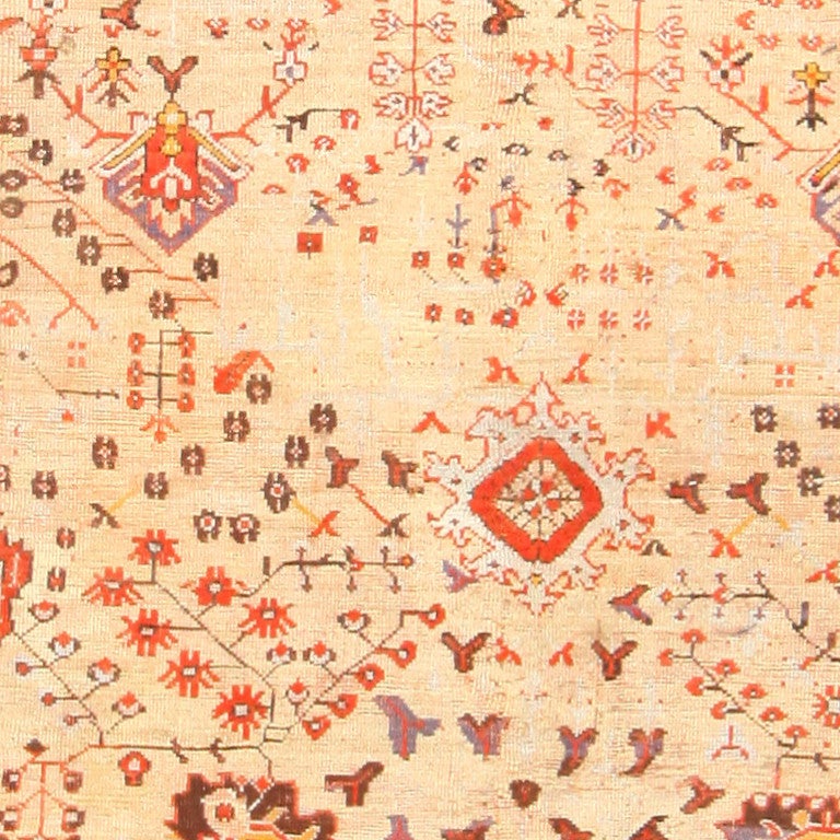 Antique Turkish Oushak Rug, Turkey, Circa 1890 - 1900 -- A woody brown hue accents the rich orange and golden colors of this lovely antique Turkish Oushak rug. Bands of abstracted flower motifs serve as a frame for the simple and uncluttered central