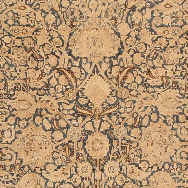 Antique Khorassan, Persia, circa 1900. A lush design of arabesque vinescrolls and palmettes unfolds in radial symmetry across the slate blue field of this sumptuous antique Khorassan. The various vines, palmettes and flowers are so closely