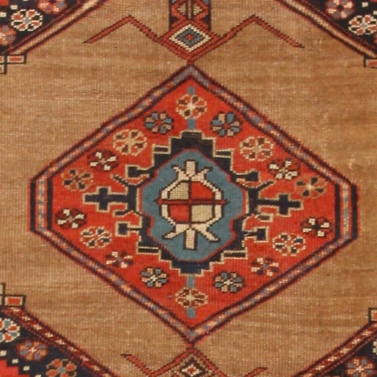 Serab Rugs are known for their fine long rugs or runners with a characteristic camel ground and lozenge-shaped medallions. These rugs are woven in the village of Serab, located near Heriz in Persia. They are now used as a trade name for certain