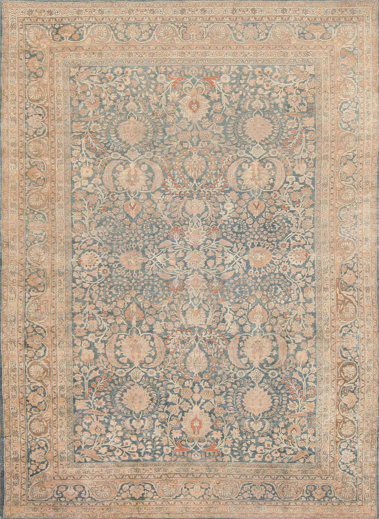 Here is a remarkable antique Persian rug, a stately composition replete with the elements of classical Persian rug design. Woven in the famed Persian rug-making center of Khorassan, this beautiful antique Oriental rug is composed in classical