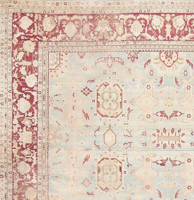 Here is an absolutely gorgeous antique oriental rug, an antique Indian Agra rug, woven in the tradition of the finest Agras. This particularly comely antique rug is primarily characterized by a sublimely beautiful, ephemeral field of light blue,