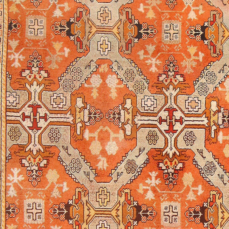 Antique Oushak carpet, Turkey, 1920. Bold, striking sunset orange defines this powerful Turkish Oushak carpet. A deceptively simple pattern of tribal motifs rendered in sand, cold, and yellow emphasize the rich orange of the base. Floral motifs,