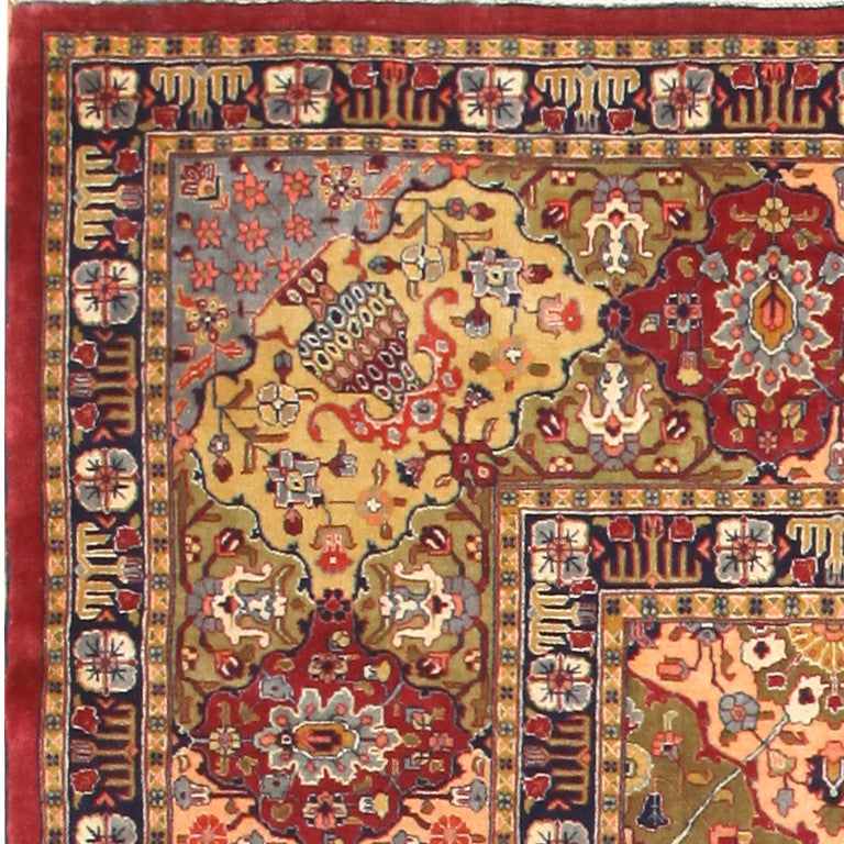 Antique Tabriz Carpet, Persia, 1900 -- A rich melting pot of colorful elements act as the centerpieces throughout this antique Tabriz carpet. While there are only two primary borders of multi-colored squares and ruby-encrusted crowns, the rest of
