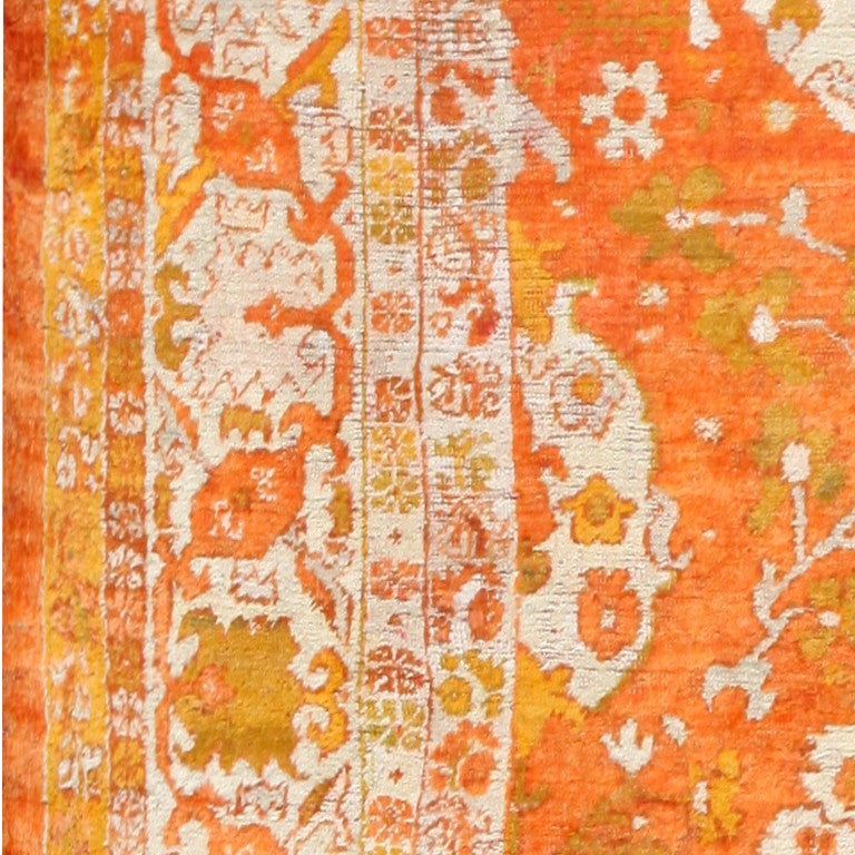 Antique Oushak Rug, Country of Origin: Turkey, Circa 1900 -- Gentle creamy ivory tones and vibrant tangerine orange hues mix together to formulate an exotic display of comfort and style in this antique rug. A spectrum of color marks the path of the