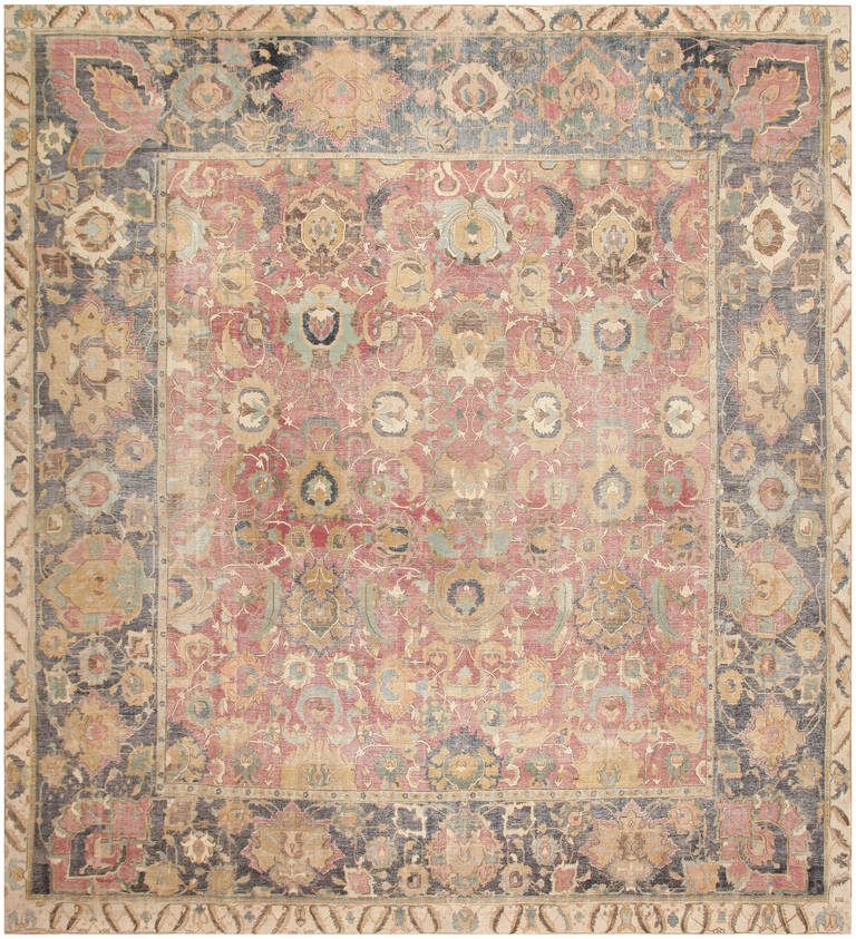 Isfahan, Persia, 17th century the outermost border has a sand tone background with alternating floral patterns appointed in indigo. There is a thinner band of darker toned sand, colored pigment broken by an indigo floral pattern. This floral pattern