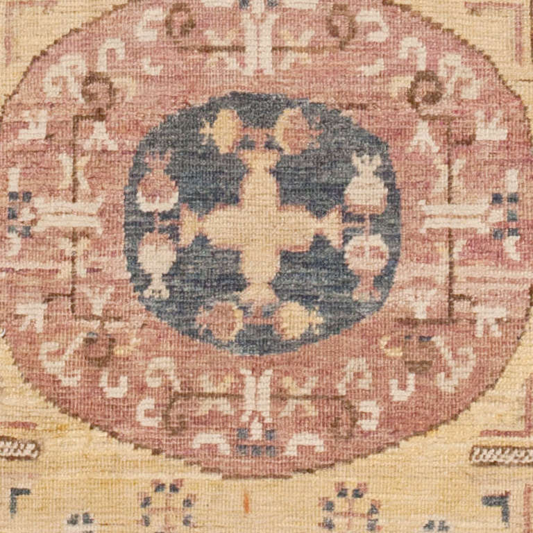 Located in Eastern Turkestan, Khotan produced fine rugs in the 18th and 19th centuries. Catering to a wide variety of tastes antique Khotan rugs straddle Chinese and western Oriental elements in their design. Space fillers are commonly used in