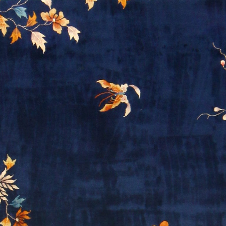 Antique Chinese Carpet, 1920 -- Like many Chinese carpets, this one effortlessly conveys a beautiful scene. The outermost border is the largest and showcases a solid gold color that seems to almost spring to life in its realistic tone gradients.