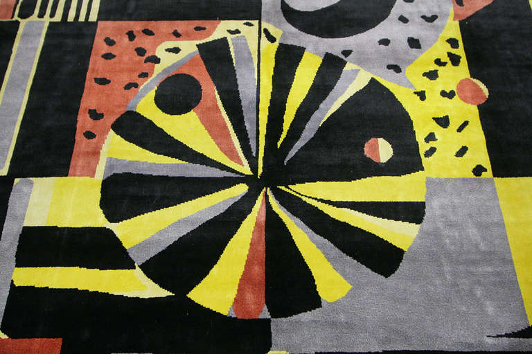 This Art Deco rug from China features bold geometric and abstract motifs rendered in a flamboyant combination of yellow, red and black set over an ecru field